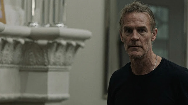 James Van Der Beek as Jacob standing by a stone altar in The Gates