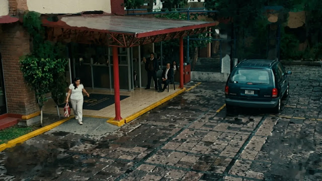 A high angle shot of a woman leaving a hospital with a bag in A Child of My Own