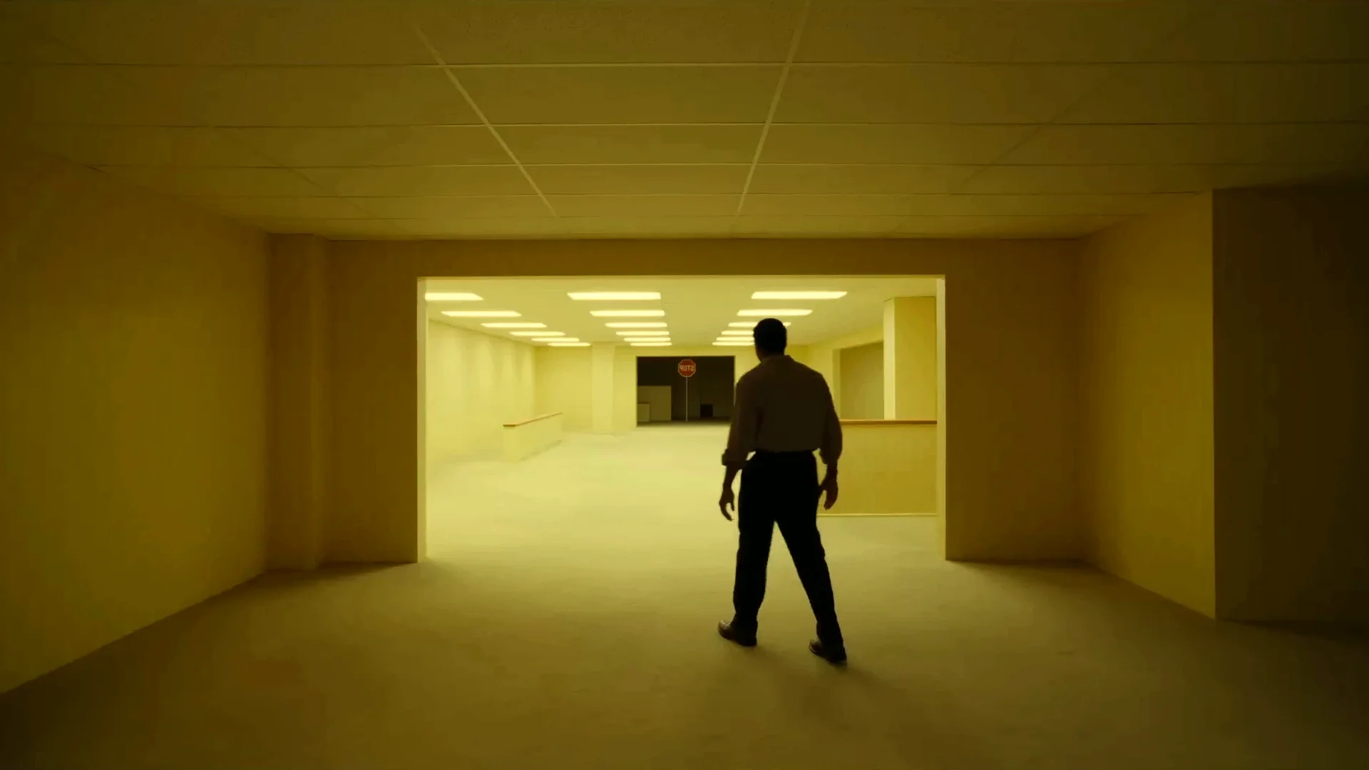 A lone figure is dwarfed by a long, empty fluorescent Backrooms corridor