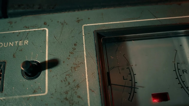 A reel-to-reel tape recorder plays archival prison recordings in the Netflix documentary The Charles Manson Tapes