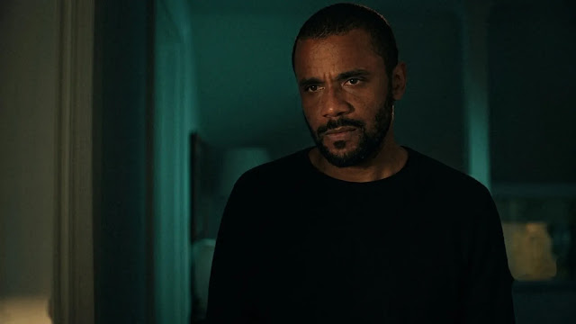 Anthony Robinson (Jarod Joseph) standing in a dim doorway at night, looking serious
