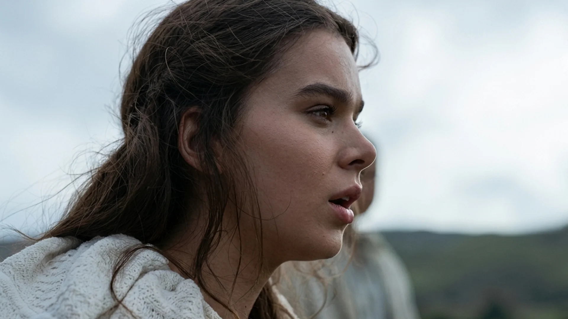 Jodie Comer, as the prioress Sister Brigid, looks to the side in a wooded landscape.