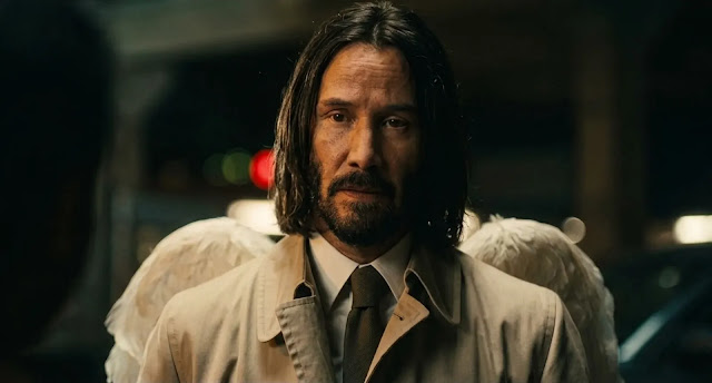 Keanu Reeves as the angel Gabriel, in a trench coat with white wings, in Good Fortune