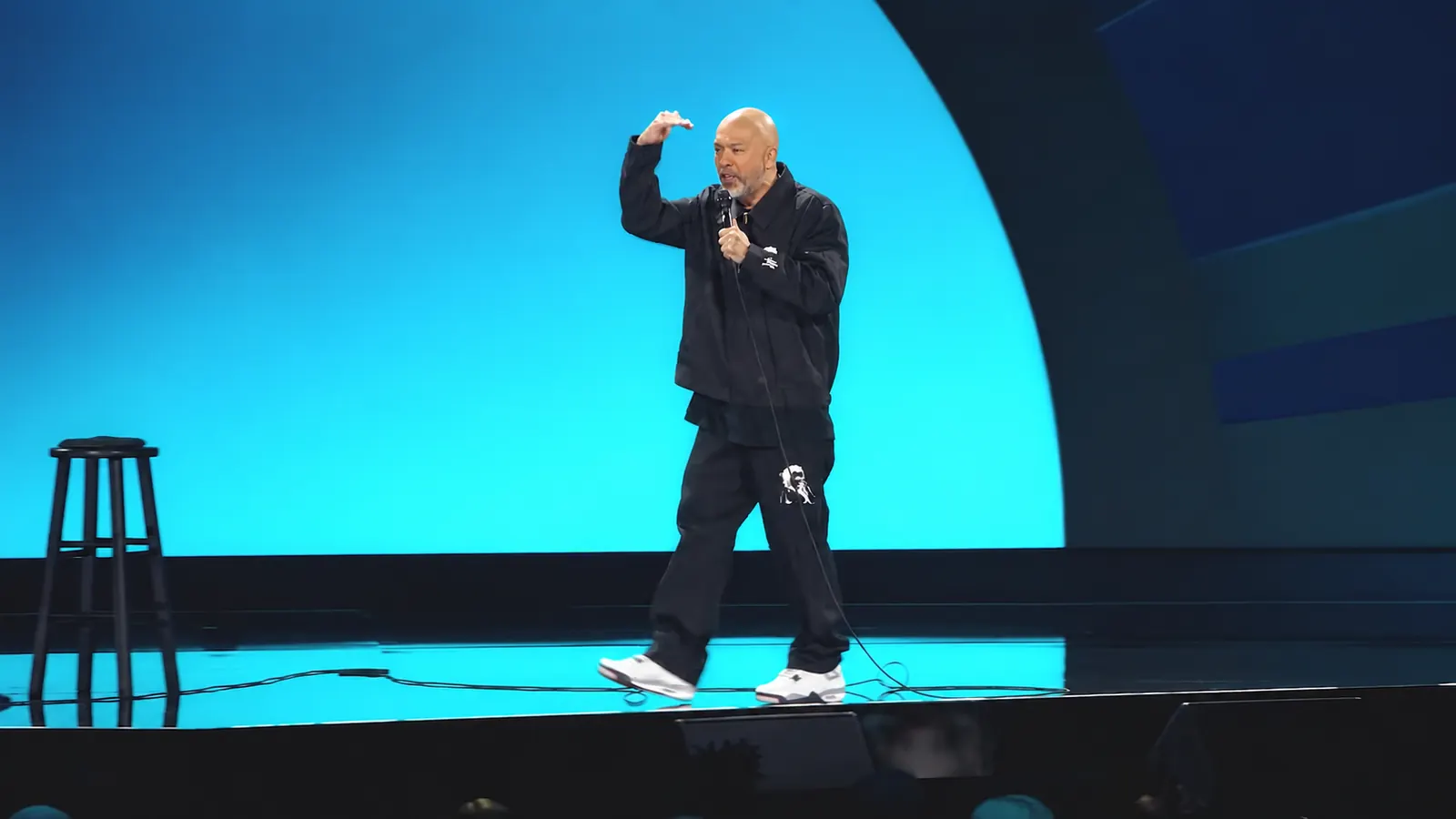 Jo Koy performs onstage before a full audience in Netflix's Blue in the Face