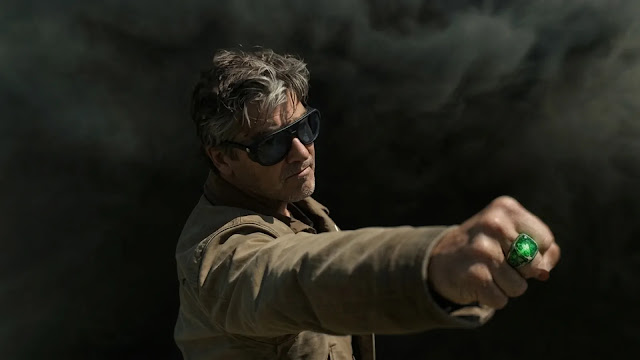 Hal Jordan (Kyle Chandler) with his green Lantern ring glowing on an outstretched fist in Lanterns
