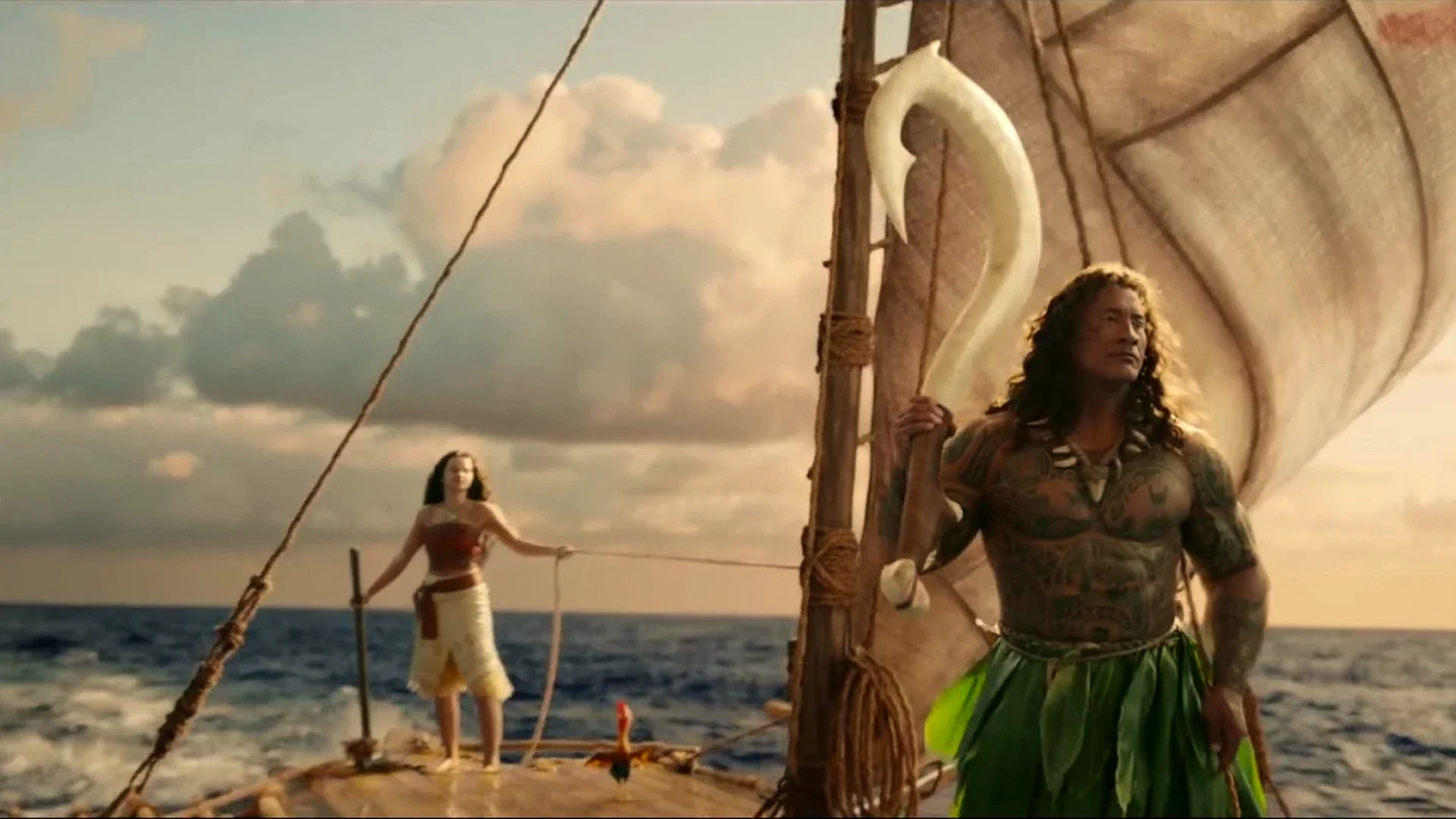 Dwayne Johnson as Maui stands beside Moana on the deck of her canoe in the live-action remake
