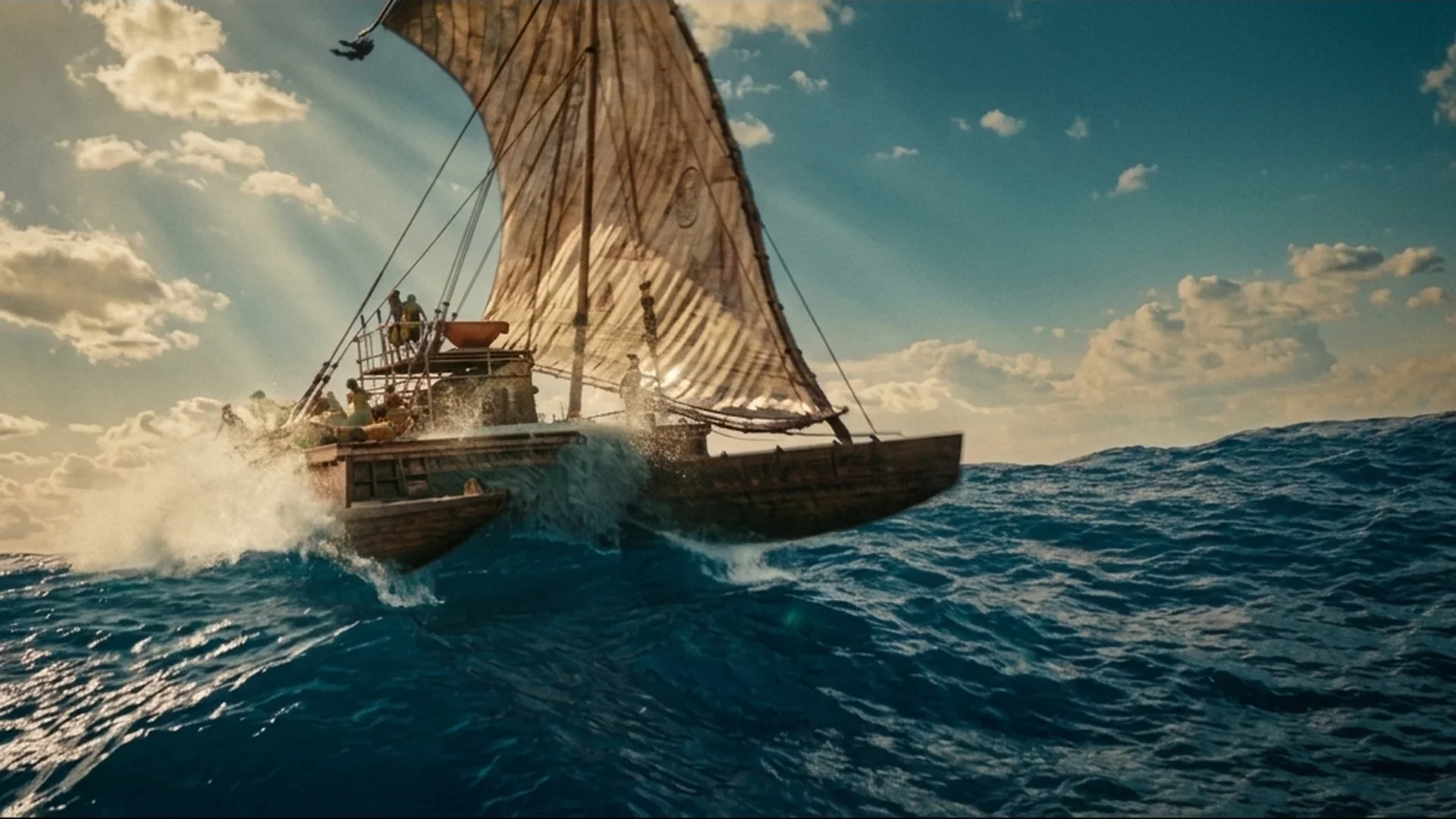 A voyaging canoe cuts through heavy ocean swells in Disney's live-action Moana