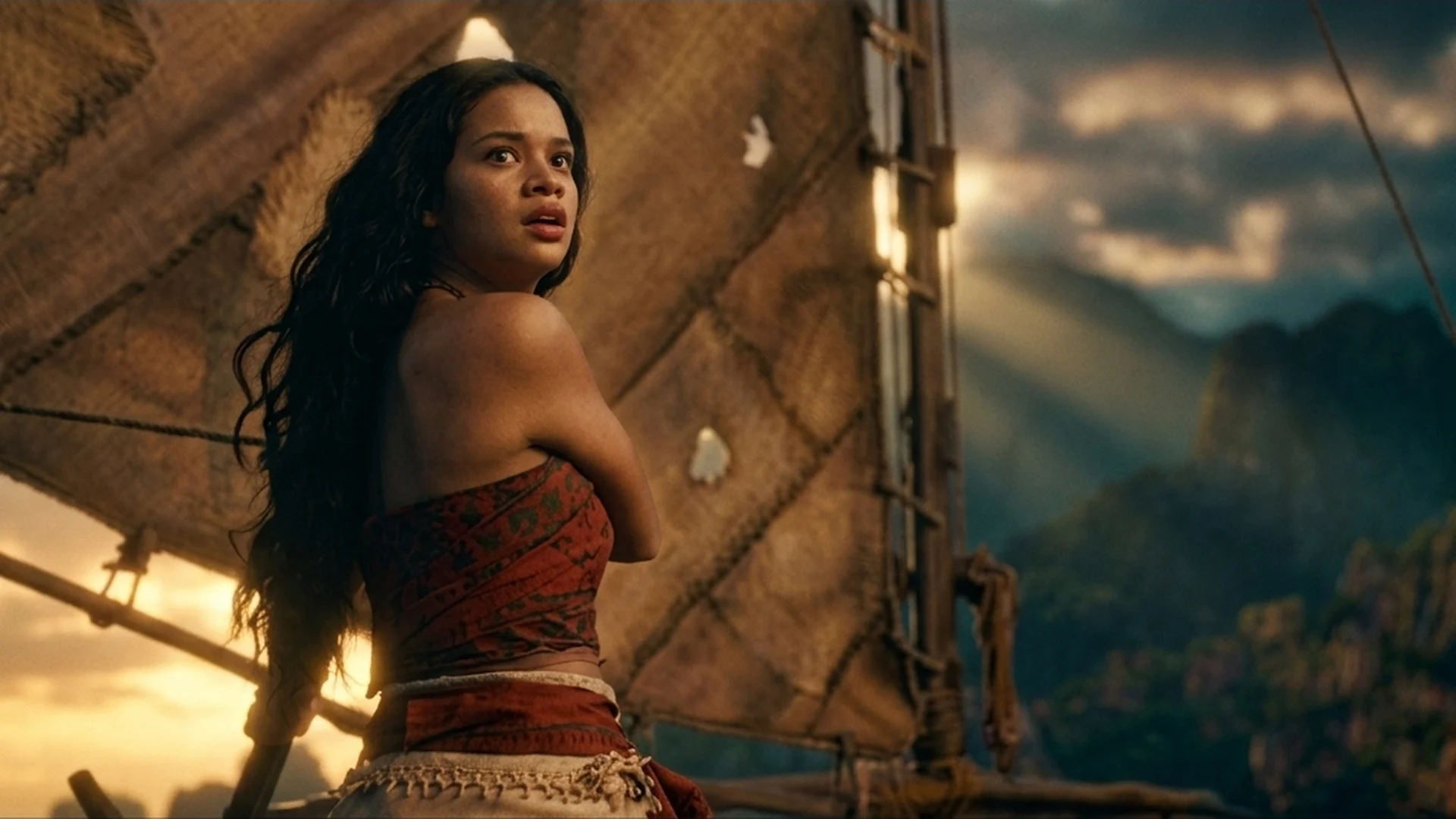 Catherine Laga'aia as Moana looking back from her canoe under sail in the live-action Moana trailer