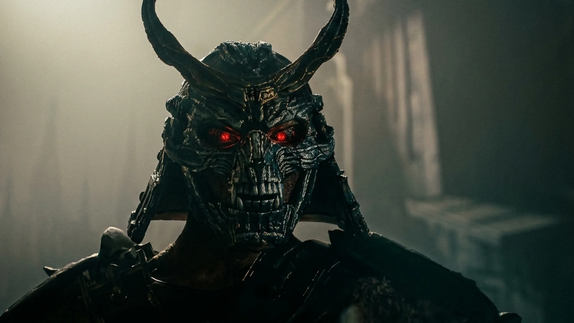 Shao Kahn, the armored Outworld emperor, glares from beneath a horned helmet, eyes glowing red
