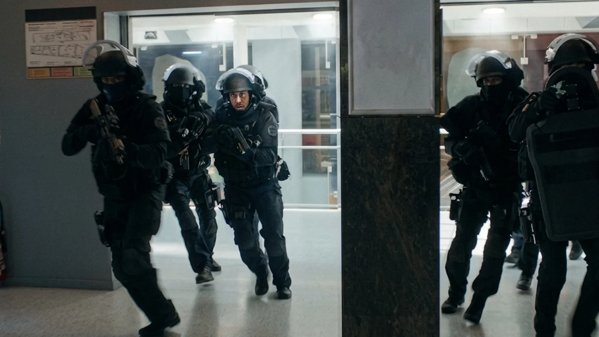 Armed police advance down a hospital corridor during the standoff in Nothing to Lose