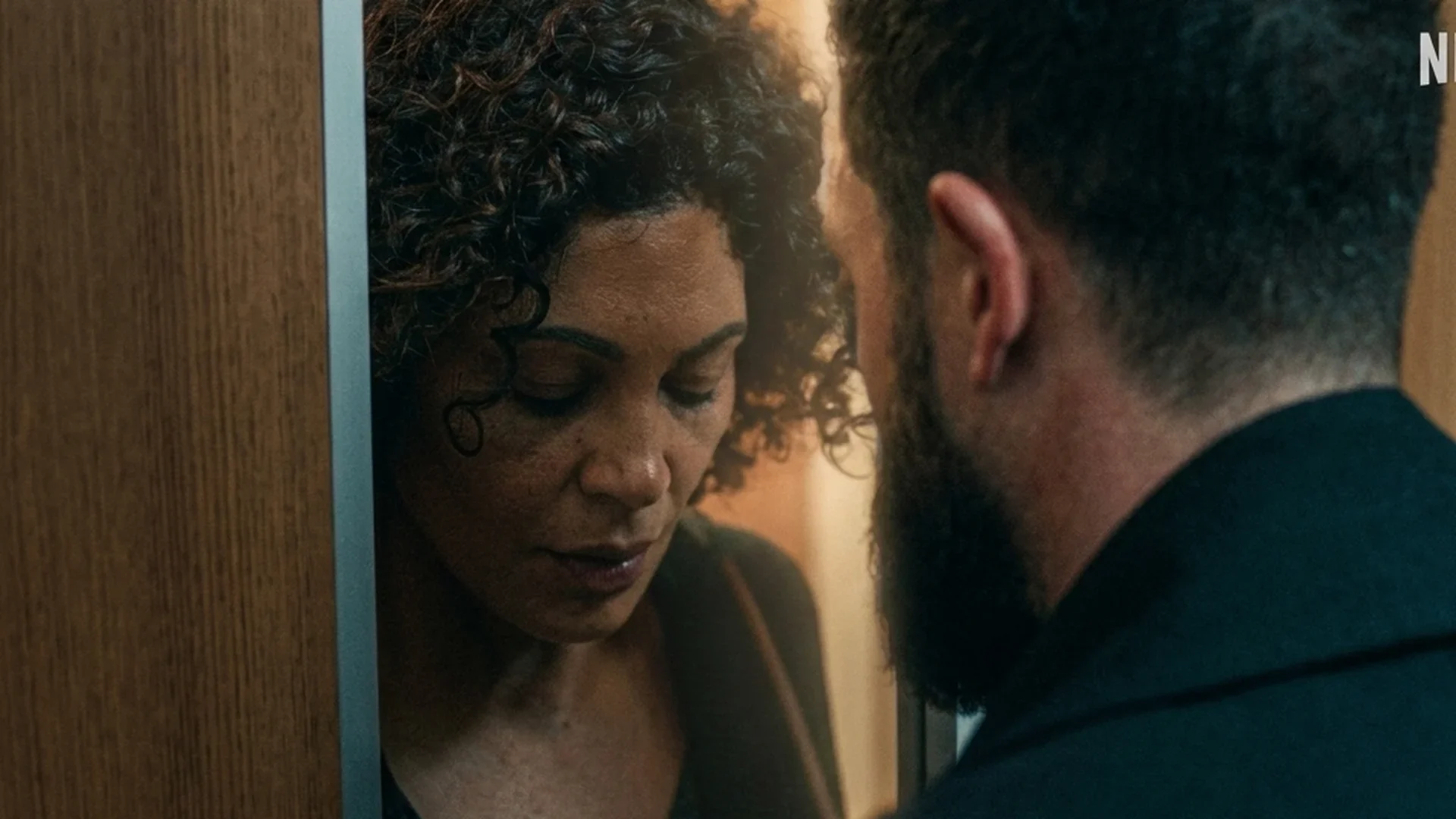 Jada and Paul share a tense moment in a doorway in Netflix's Nothing to Lose