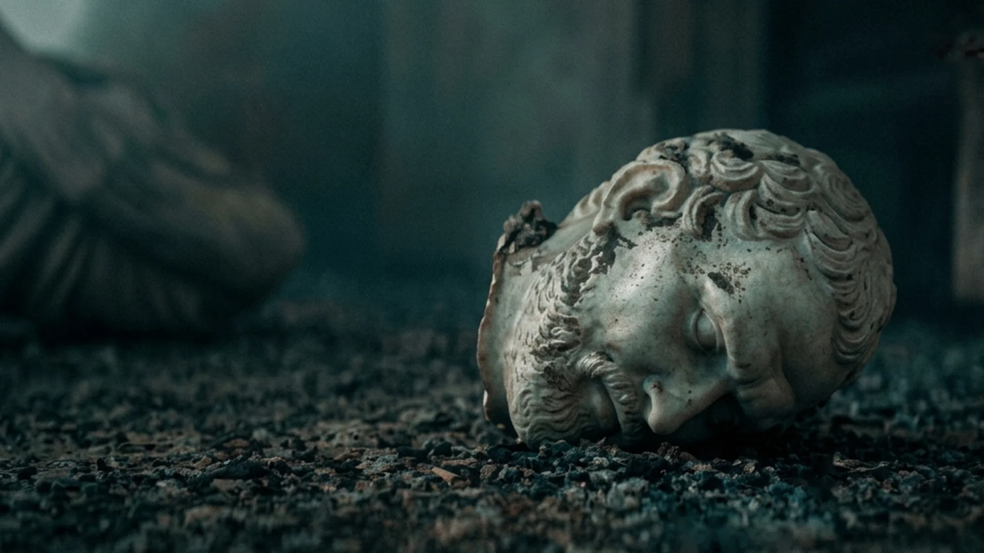 A plaster cast of a Pompeii victim rests on the dark ground