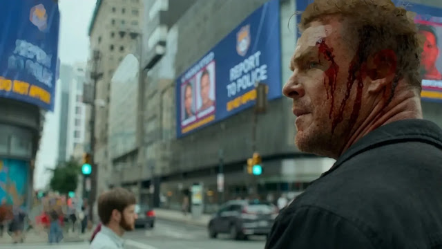A bloodied Jack Reacher on a city street beneath wanted billboards in Reacher Season 4