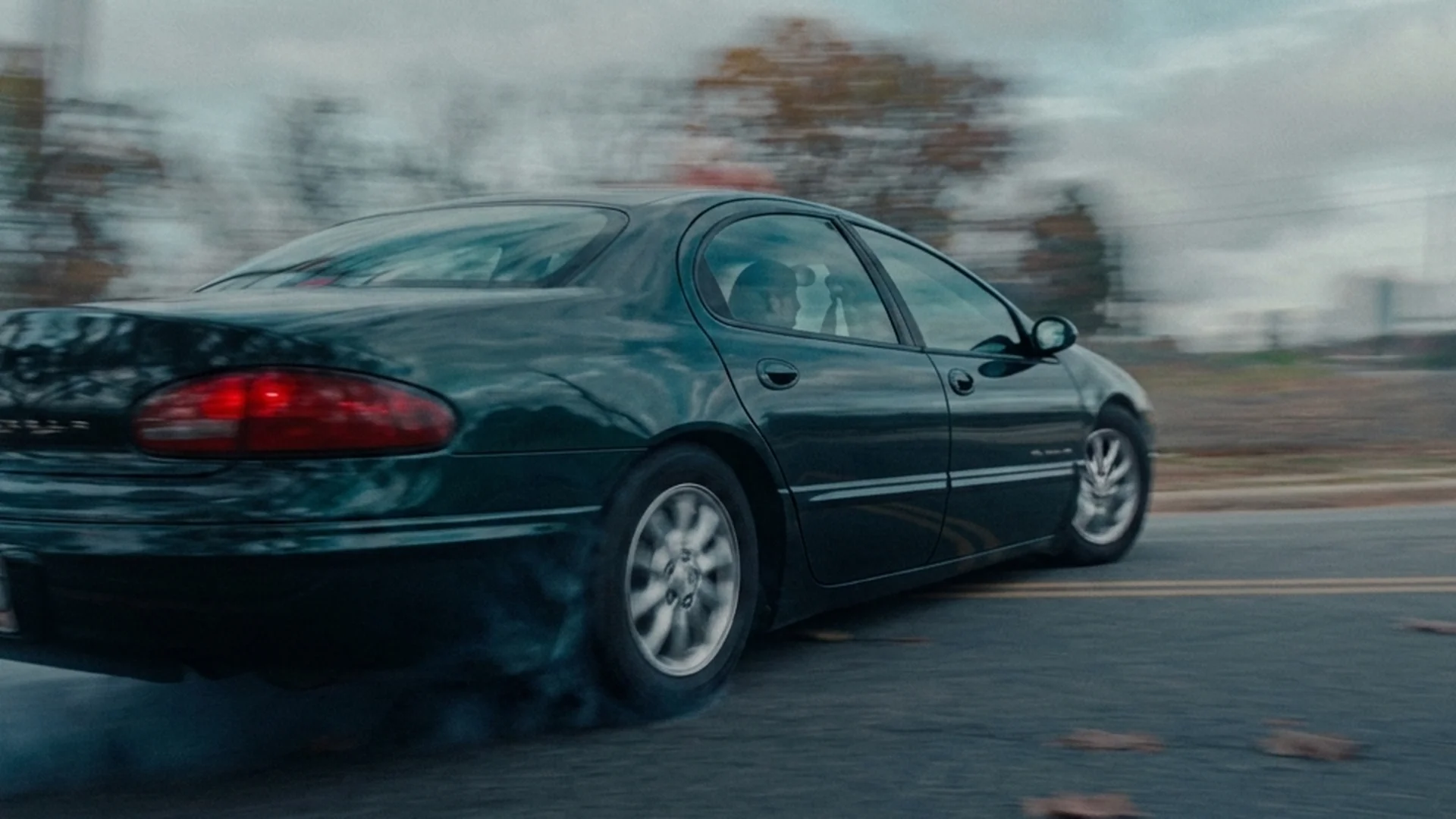 A car speeds down an open road in Roofman