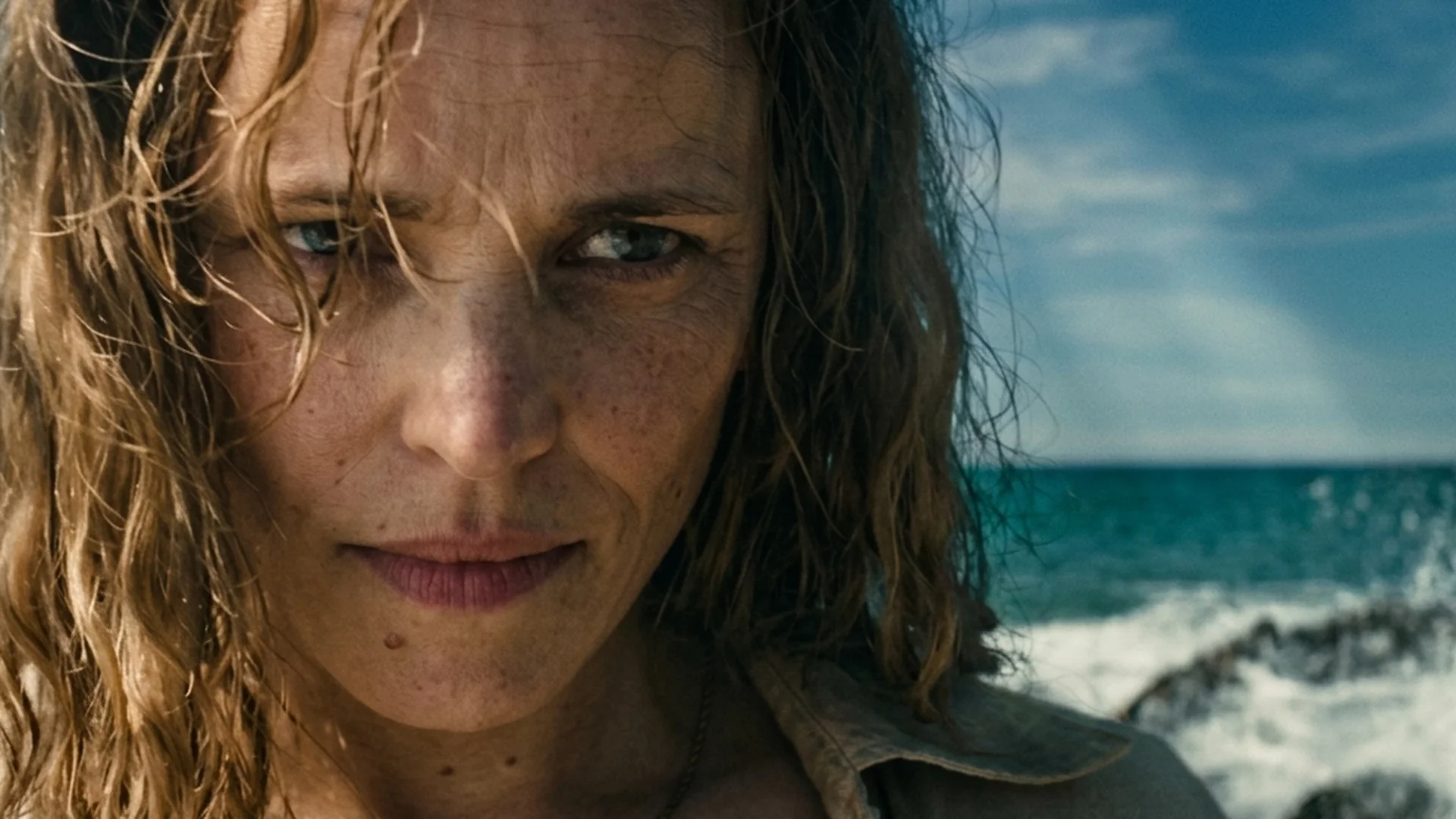 Rachel McAdams as Linda stands on a deserted beach staring inland in Send Help
