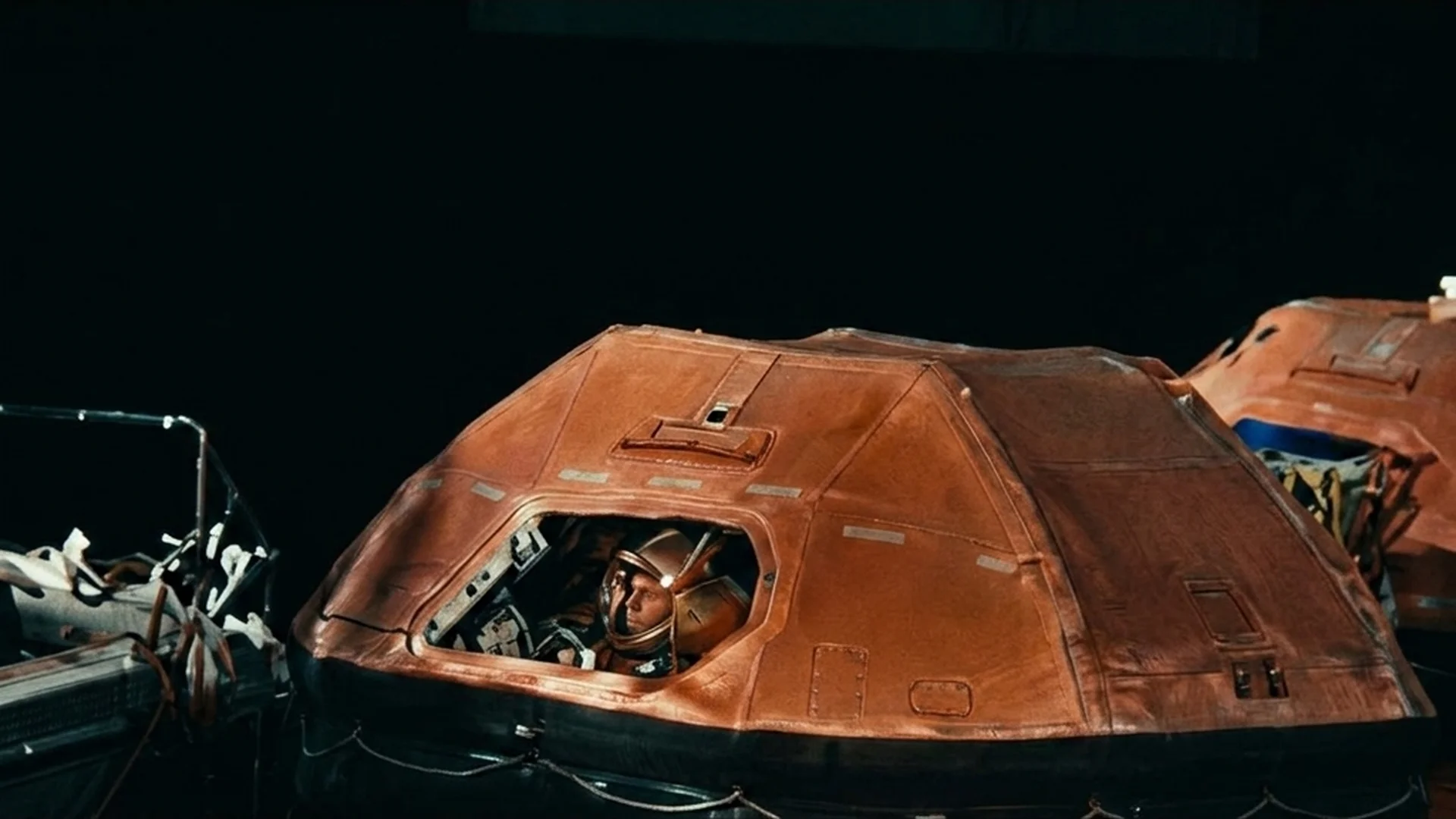 An orange lifeboat from the Costa Concordia on dark water on the night of the disaster in Shipwrecked: Nightmare at Sea