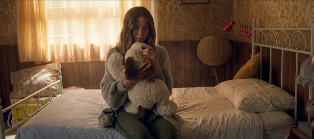 Maureen alone with her daughter's stuffed toy, in the long wait for any word