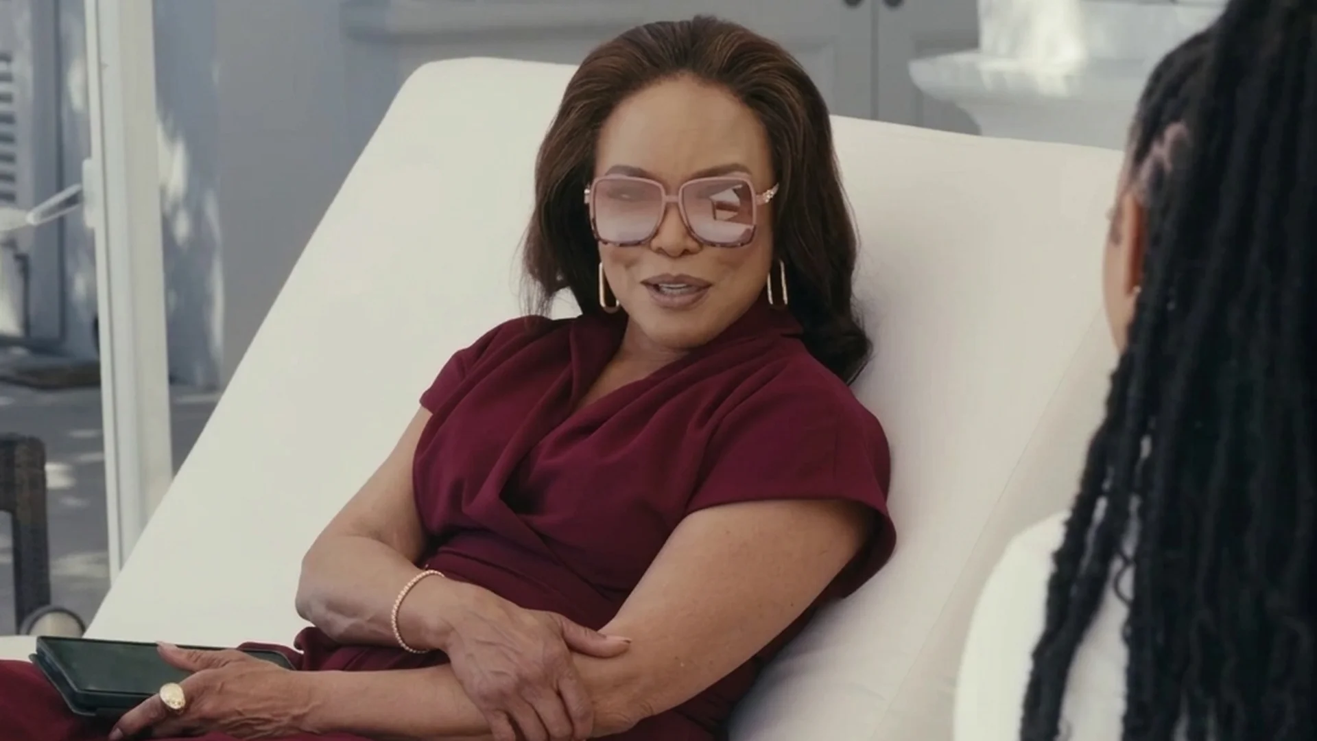Lynn Whitfield as Audra reclines on a lounger with a cool, appraising look in Strung