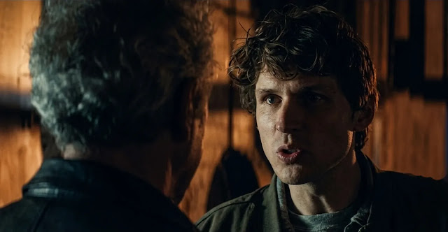Guy Anatole (Nicholas Denton) looking alarmed in a shadowed room in Talamasca: The Secret Order