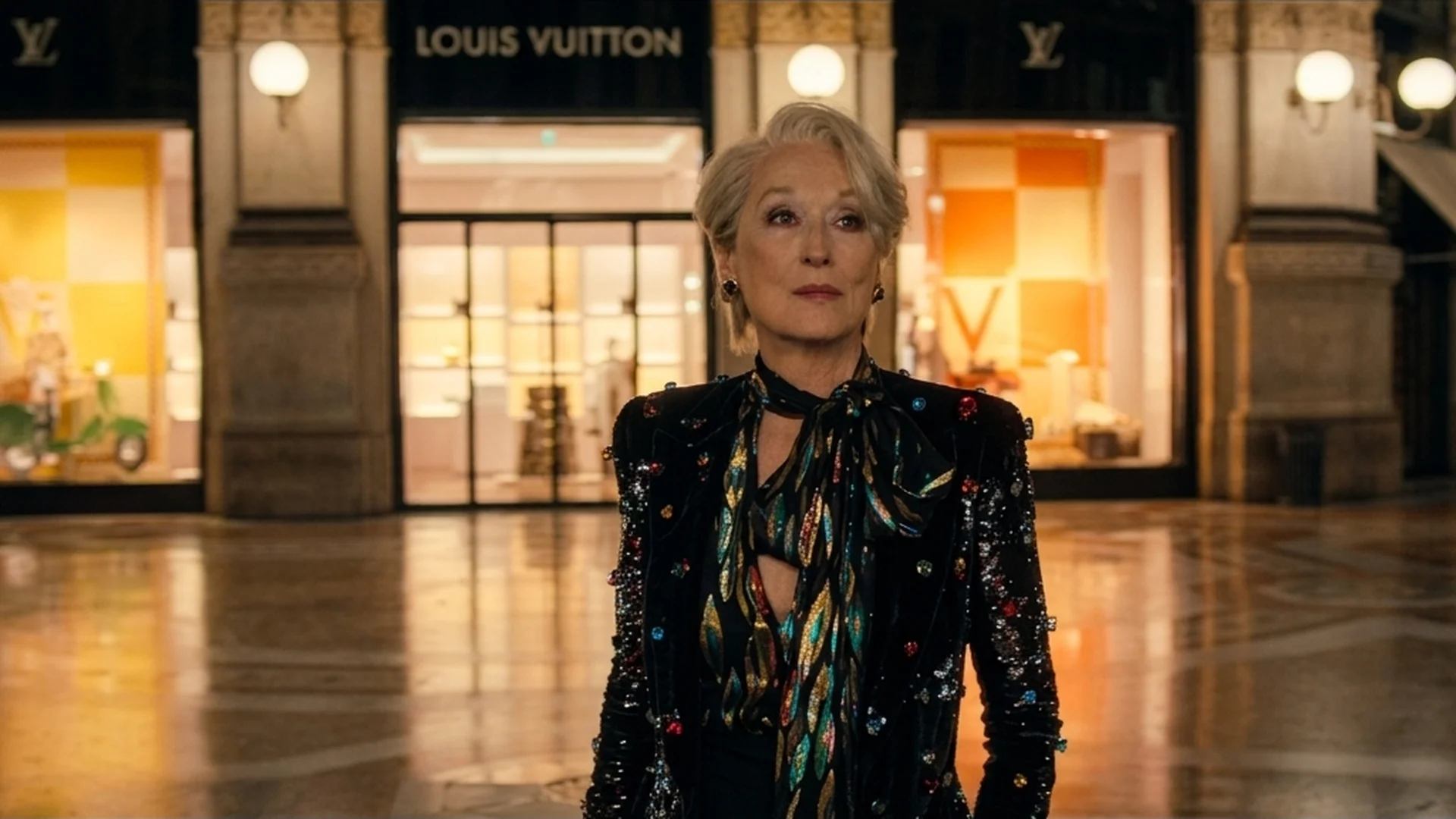Miranda Priestly (Meryl Streep) standing alone in an empty Milan shopping arcade in The Devil Wears Prada 2