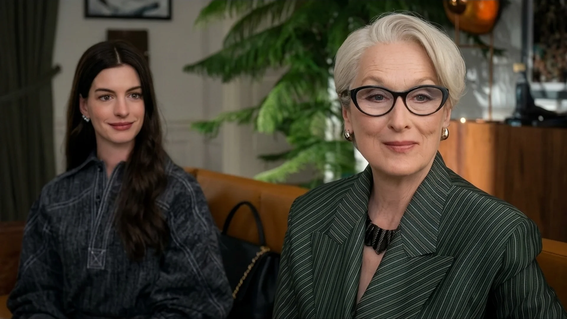 Miranda Priestly (Meryl Streep) and Andy Sachs (Anne Hathaway) sitting together on a couch in The Devil Wears Prada 2