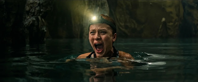 Sara (Kathryn Newton) in the dark flooded cave water
