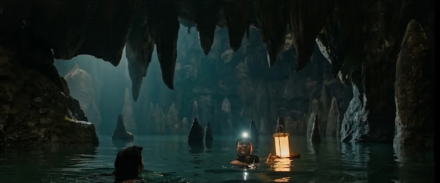 The flooded cave interior lit by a lantern