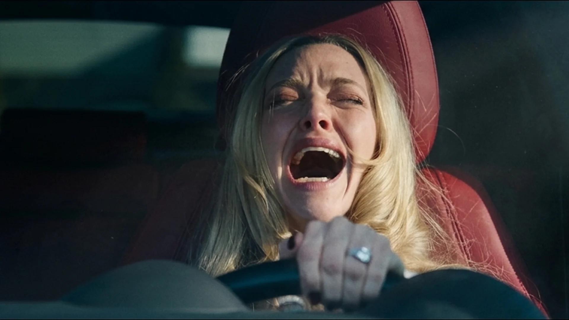 Amanda Seyfried as Nina screaming behind the wheel of a car in The Housemaid trailer