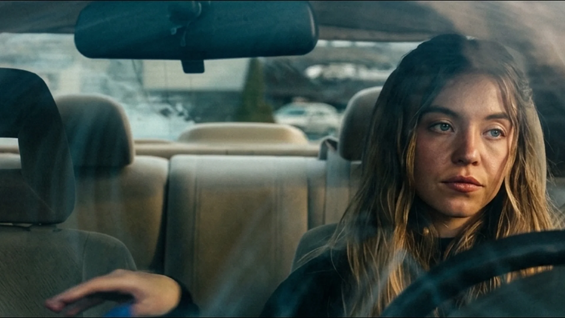Sydney Sweeney as Millie driving a car in The Housemaid trailer