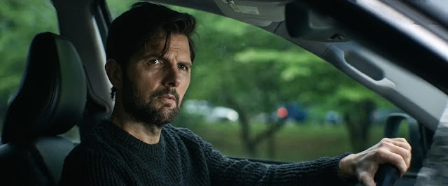Tom Kennedy (Adam Scott) behind the wheel, grim, in The Whisper Man