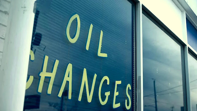 OIL CHANGES hand-painted on the front window of the Valley Forge auto shop in Tires