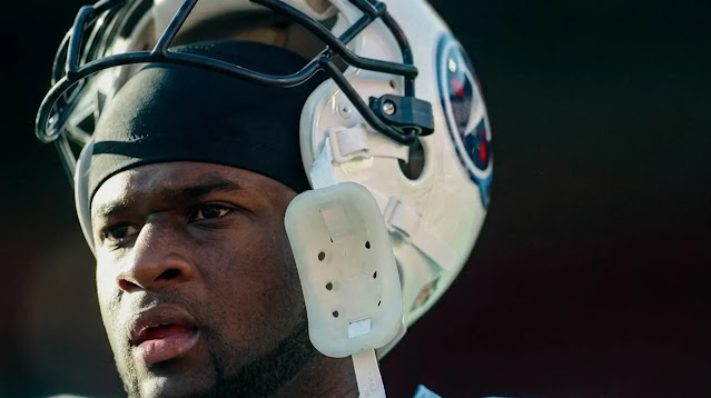 Vince Young holding his Tennessee Titans helmet during his NFL career