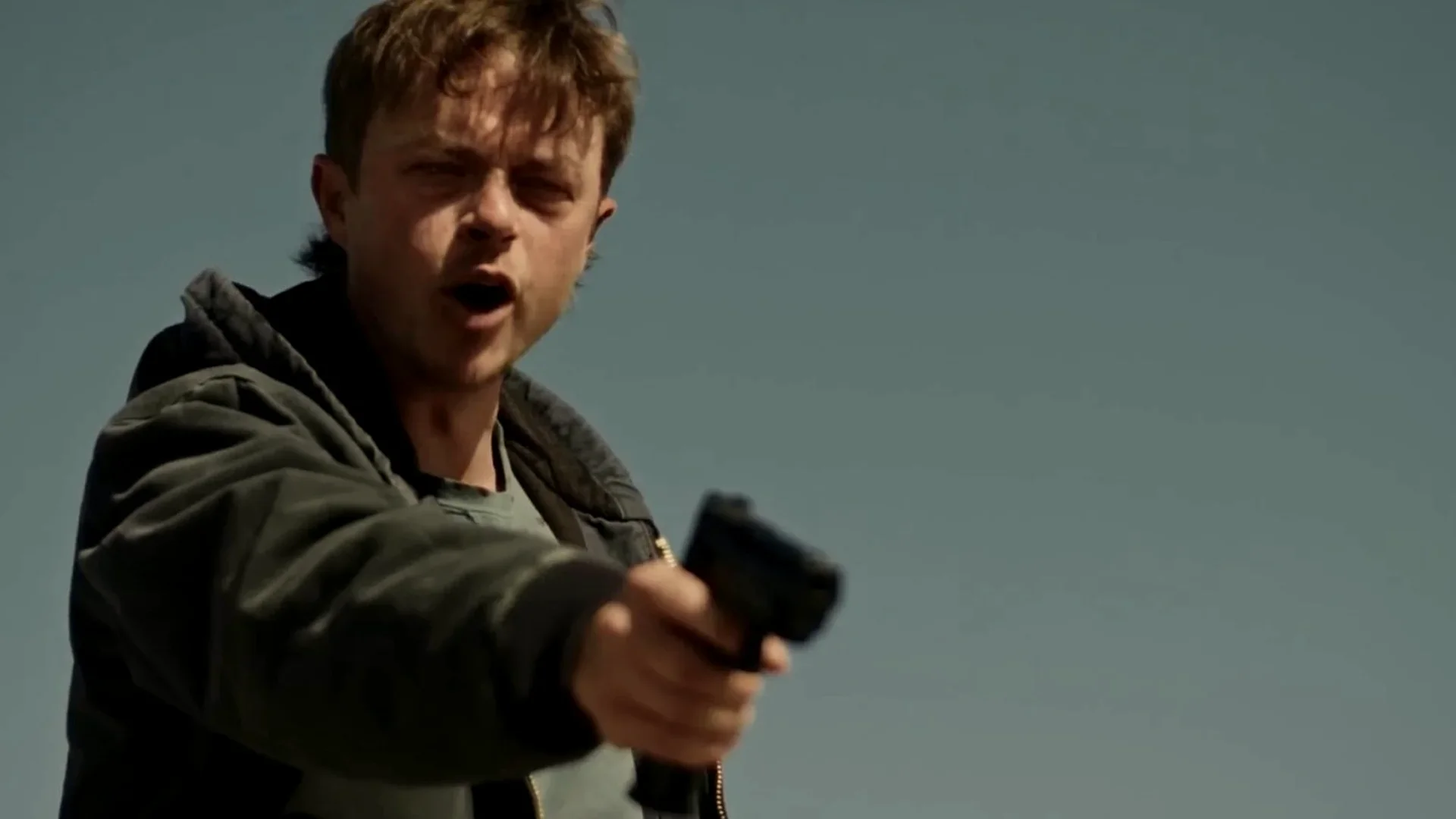 Cole points a handgun while wearing a hooded jacket in Wardriver