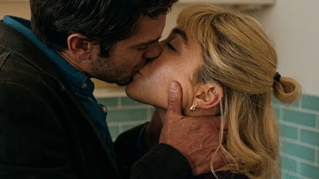 Almut (Florence Pugh) and Tobias (Andrew Garfield) kiss in a kitchen in the We Live in Time trailer